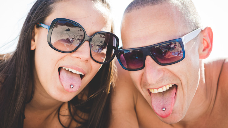 couple at the beach with tongue piercings