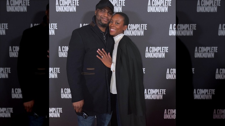 Tracy Ifeachor with her hand on her husband's chest on a red carpet.