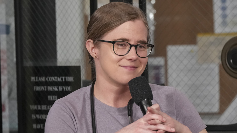 Taylor Dearden in character as Dr. Melissa King holding mic during interview on set of "The Pitt"