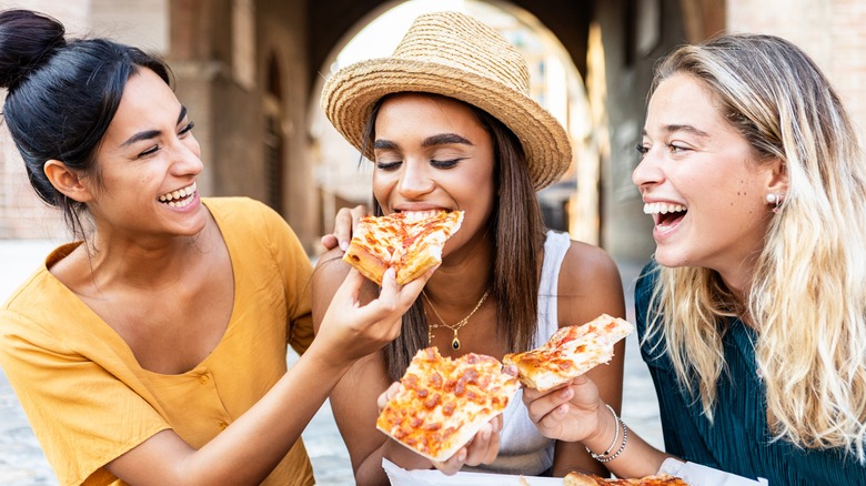 girls eating pizza