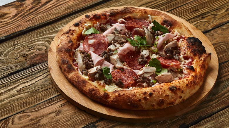meat pizza on pizza round