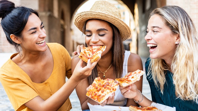 Women eating pizza