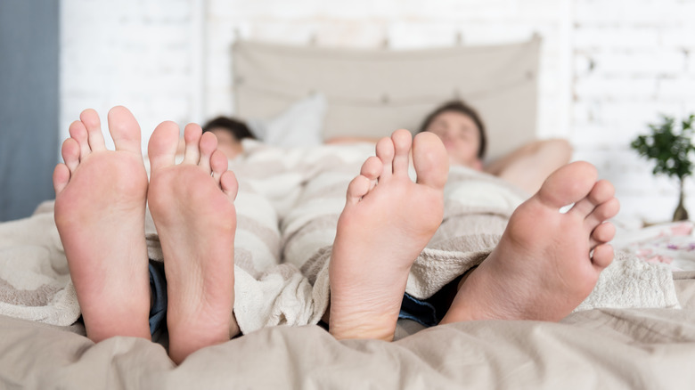 Couple lounges in bed