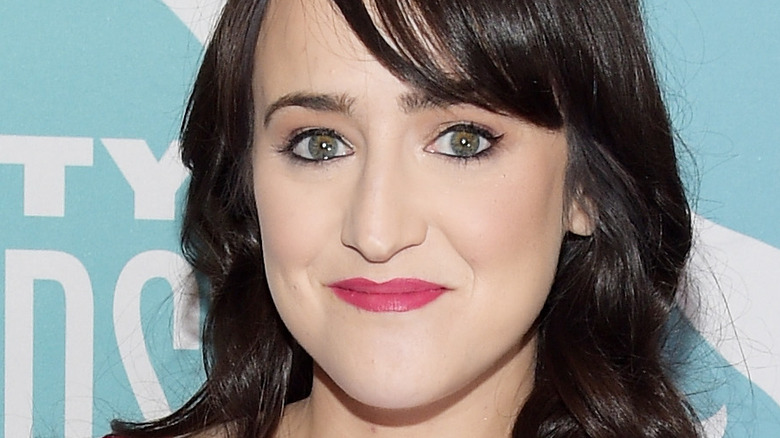 Mara Wilson smiles and poses at an event