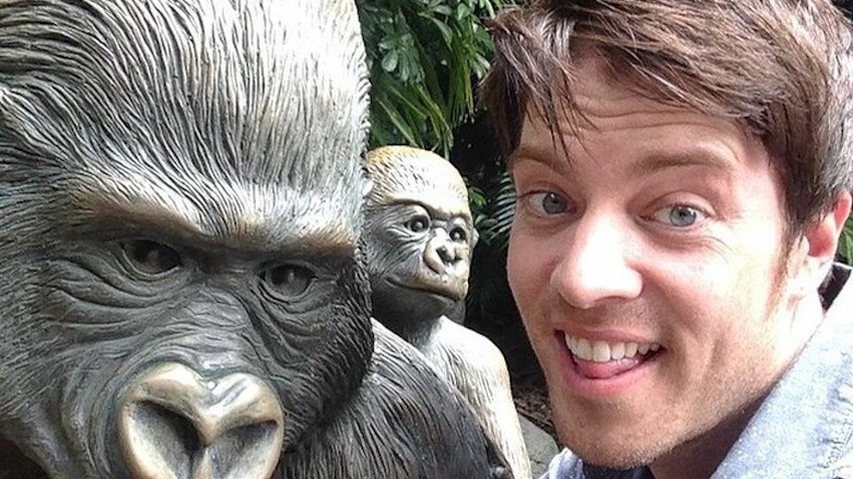 J.D. Scott in a selfie he took at a zoo next to an ape statue