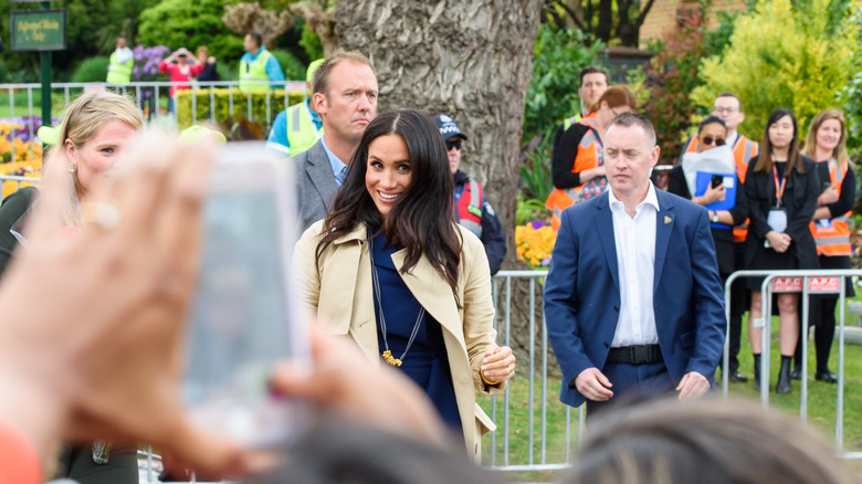 Meghan Markle making her way through a crowd during her and Prince Harry's Australia tour in 2018