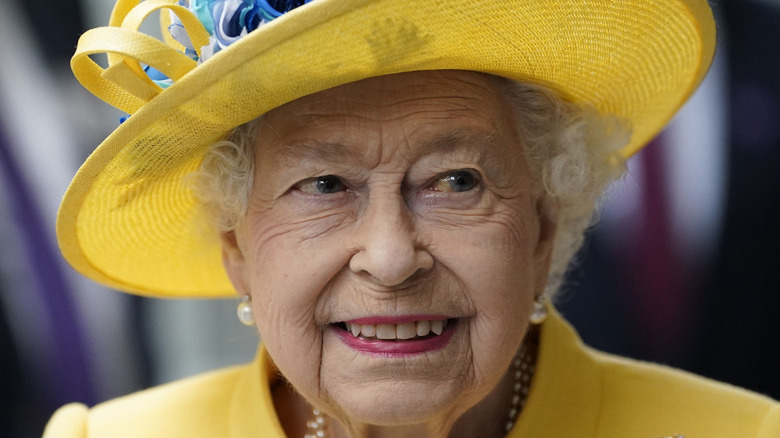 Queen Elizabeth wearing yellow hat