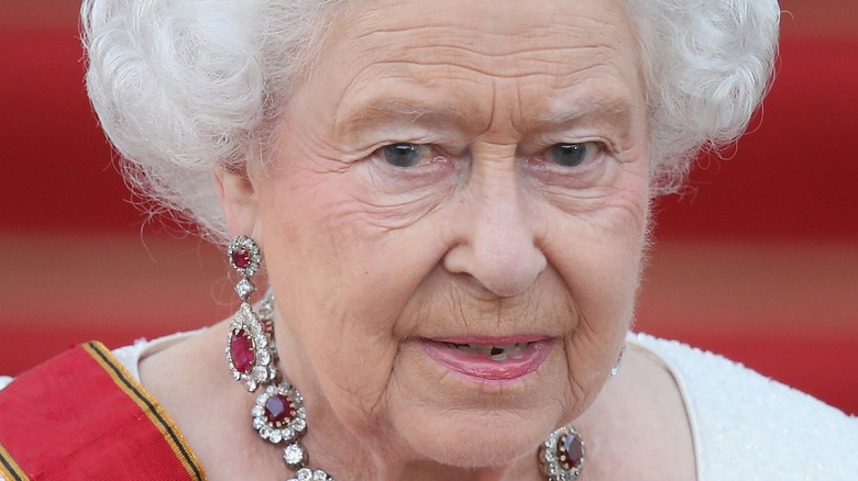 Queen Elizabeth attends an event in her crown and sash