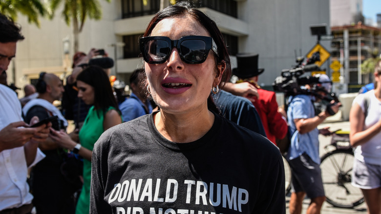 Laura Loomer protesting Donald Trump's address in a 'Donald Trump did nothing wrong' shirt and sunglasses