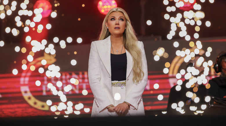 Erika Kirk standing on a stage with fireworks