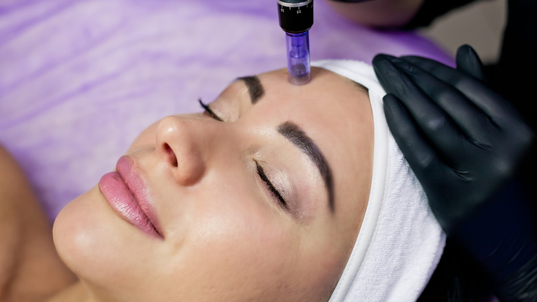 Woman smiling while getting her facial