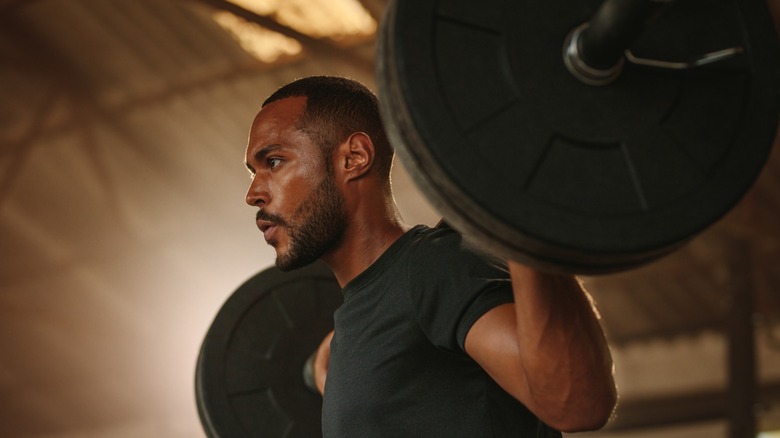 man lifting gym weights