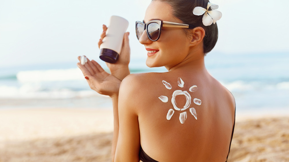 Woman with sunscreen on back