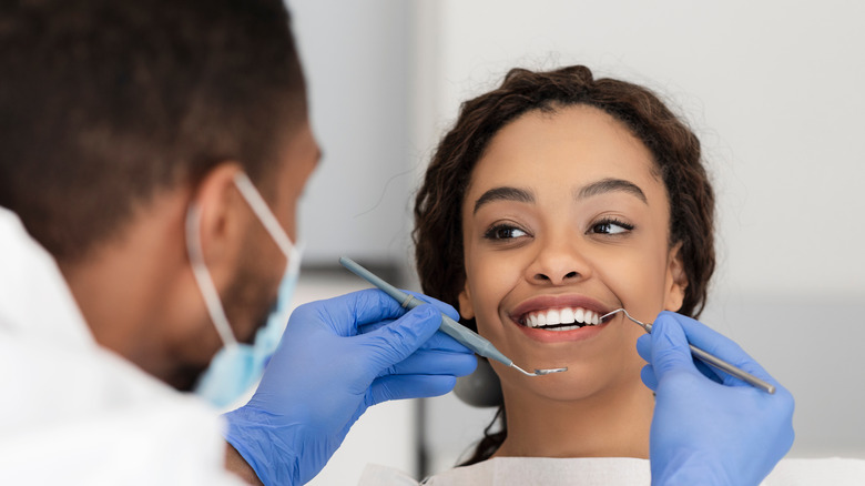 Woman in dentist chair smiling
