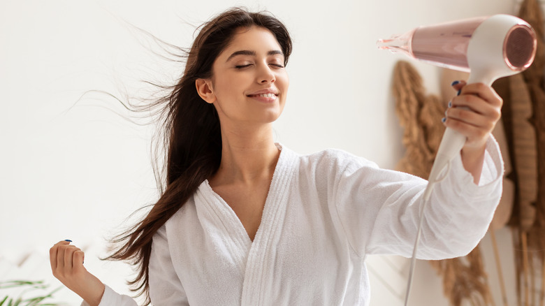 Woman blowdrying hair