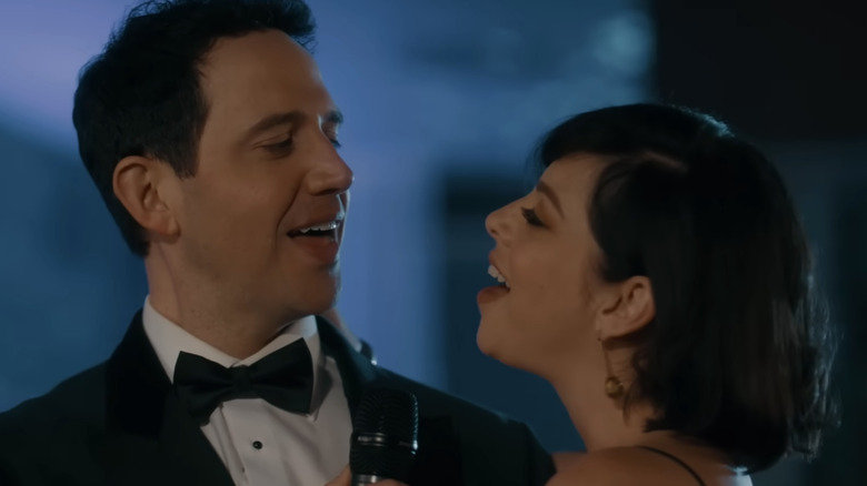 Krysta Rodriguez  and Santino Fontana sing smiling turned toward each other in the Hallmark movie "Just One Kiss"
