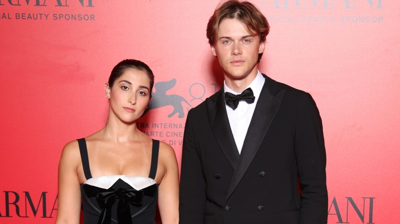 Christopher Briney posing with girlfriend Isabel Machado at an event