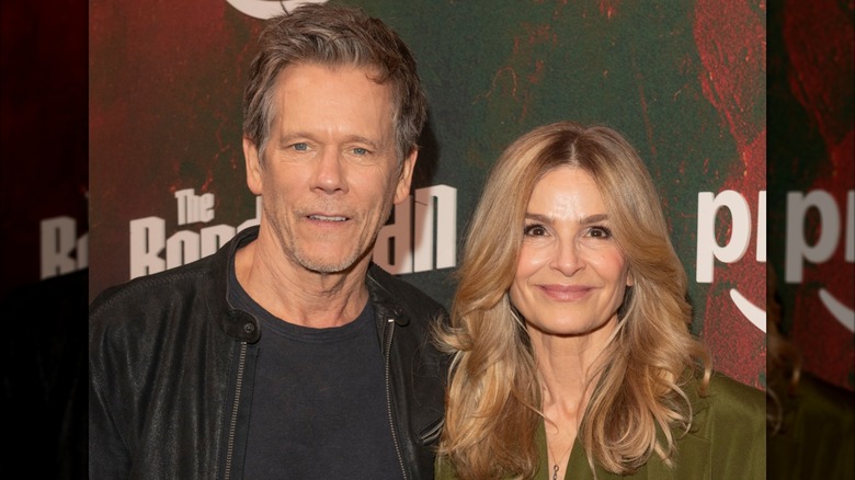 Kyra Sedgwick posing with husband Kevin Bacon at an event