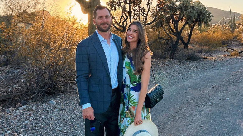 Rhett Ellison and Raina Hein standing in front of a sunset