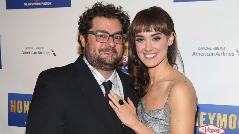Bobby Moynihan and Brynn O'Malley with their arms around one another.