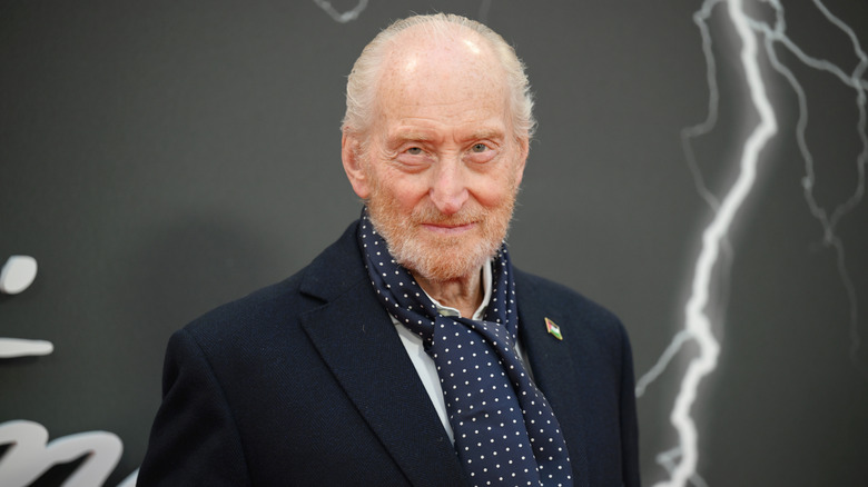 Charles Dance posing for photos in a suit