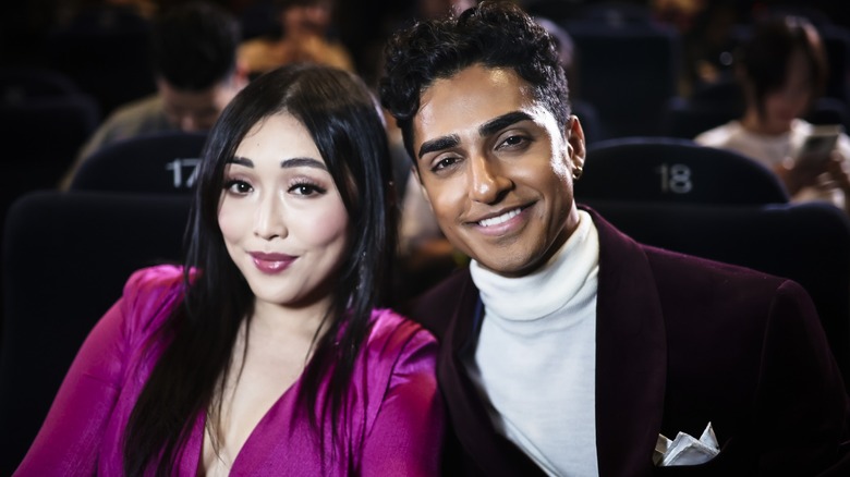 Jill V. Dae and Anirudh Pisharody dressed up and sitting in a movie theater together