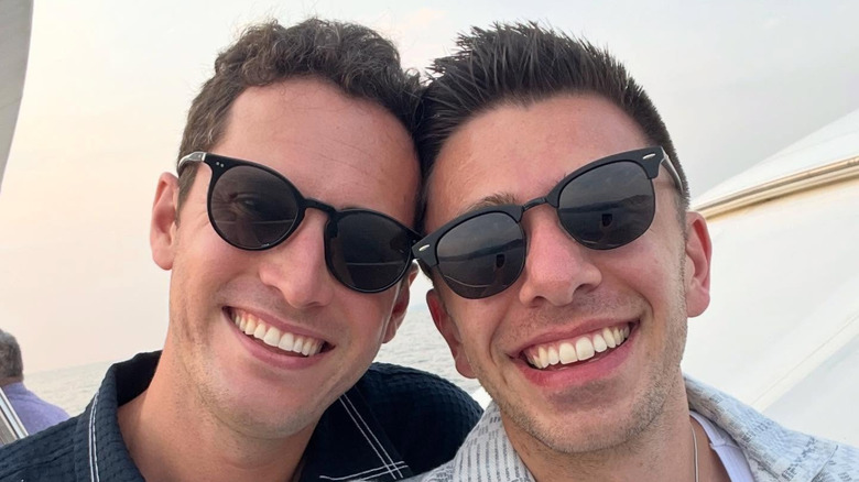 Brad from The Middle smiling in a selfie with his boyfriend wearing black sunglasses