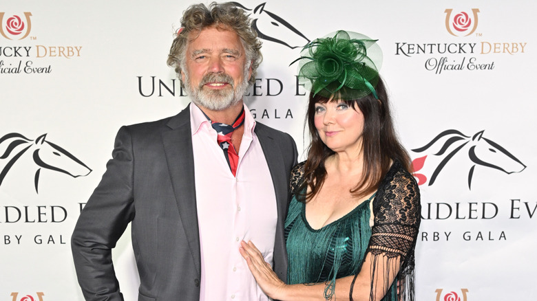 John and Dee Dee Schneider posing at a Kentucky Derby event in 2024