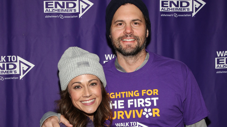 Kristoffer Polaha arm around Nikki Deloach