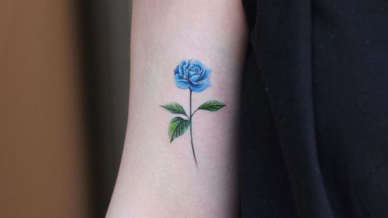 Blue rose tattoo on the ankle.