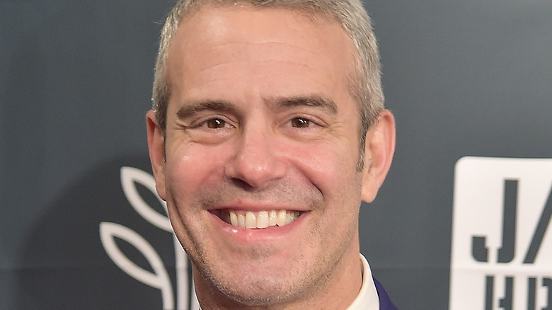 Andy Cohen smiles on the red carpet