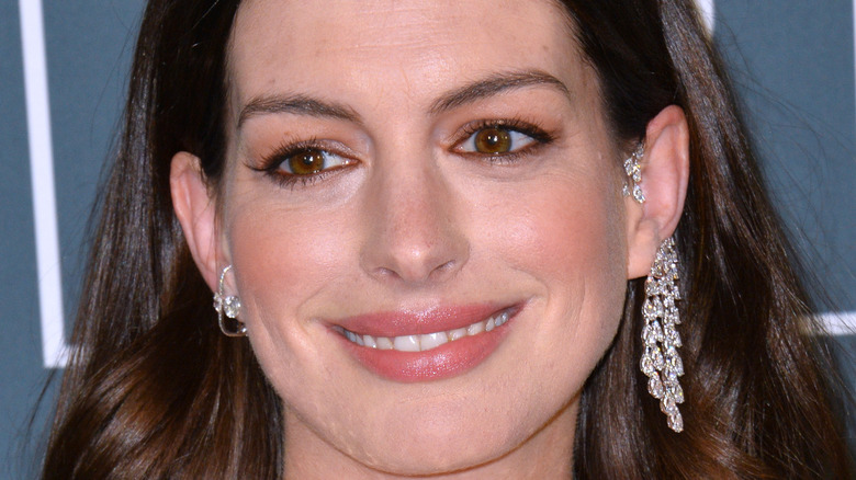 Anne Hathaway smiling on the red carpet 