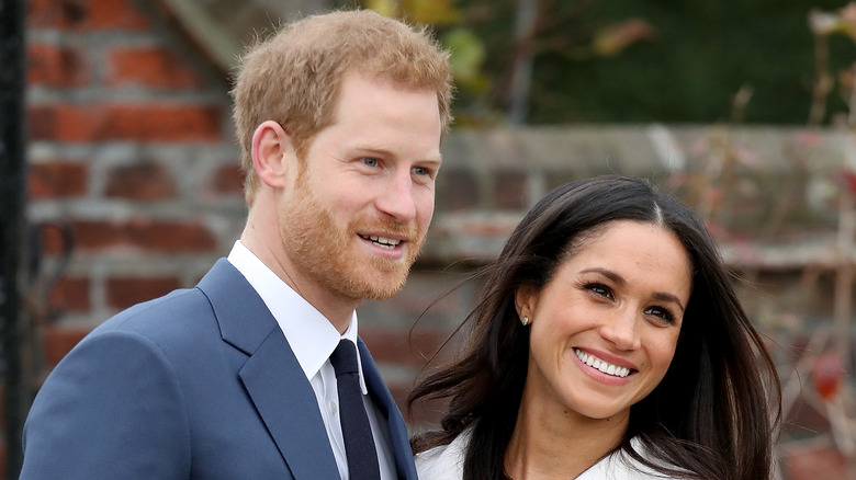 Meghan and Harry smile for photographers