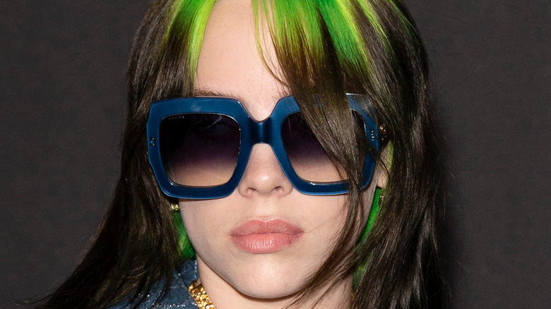 Billie Eilish in 2019 with black and green hair