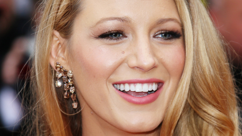 Blake Lively smiles with her hair down.