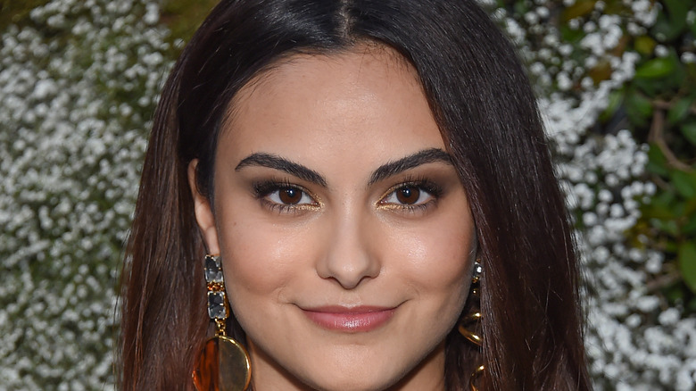 Camila Mendes poses at an event