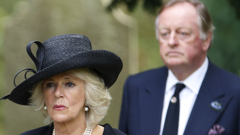 Camilla Parker Bowles with Andrew Parker Bowles walking behind her 