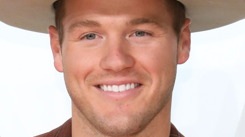 Colton Underwood smiling in hat