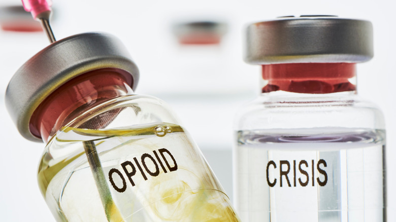 Medicine bottles labeled "opioid" and "crisis"