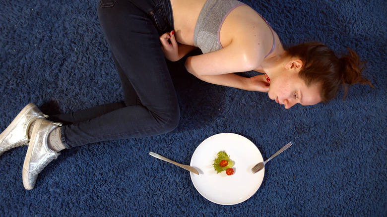 Woman staring at small salad