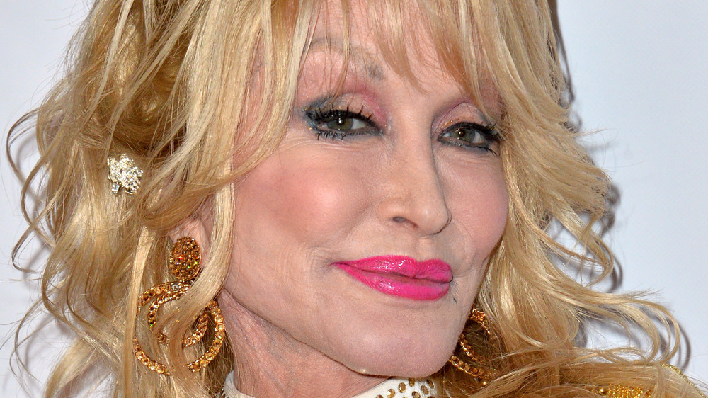 Dolly Parton pink lipsticked head tilted