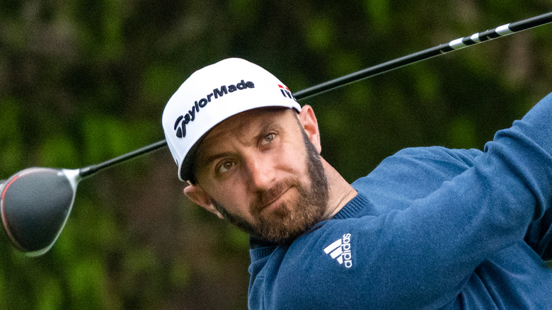 Dustin Johnson swings his golf club