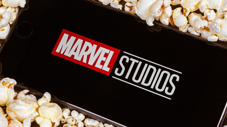 Marvel Studios logo on phone surrounded by popcorn