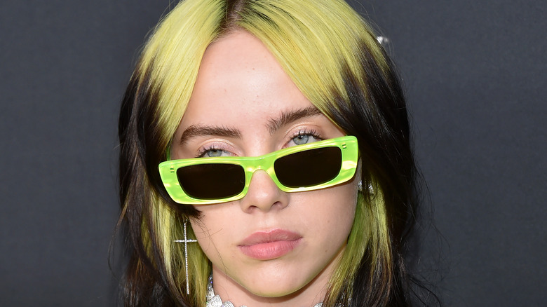 Billie Eilish wearing green glasses