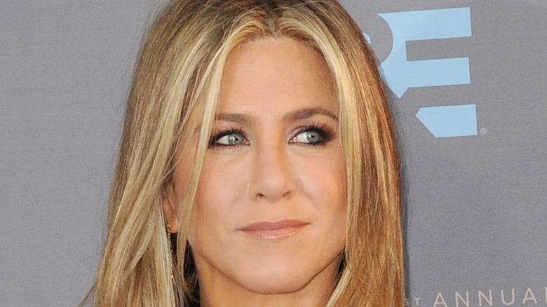 Jennifer Aniston smiling, looking sideways 