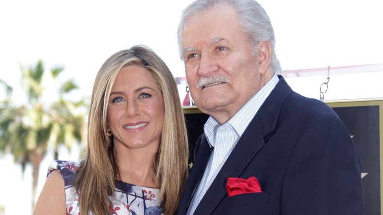 Jennifer Aniston and John Aniston posing 