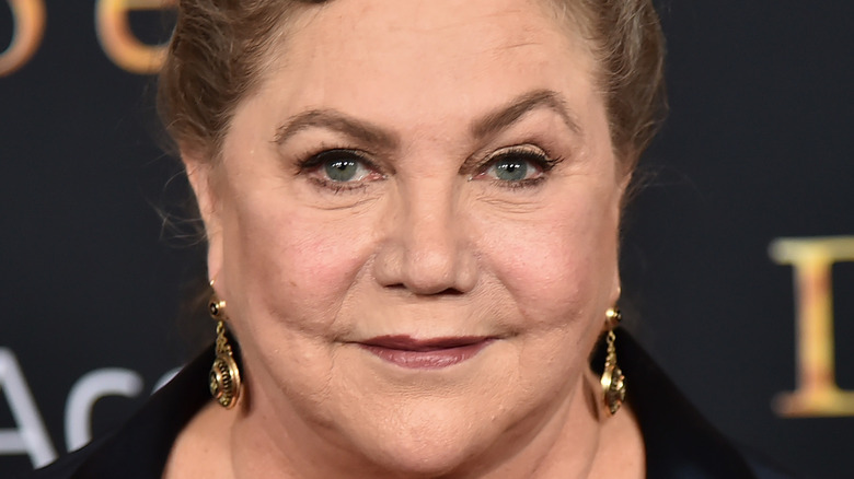 Kathleen Turner raising one eyebrow