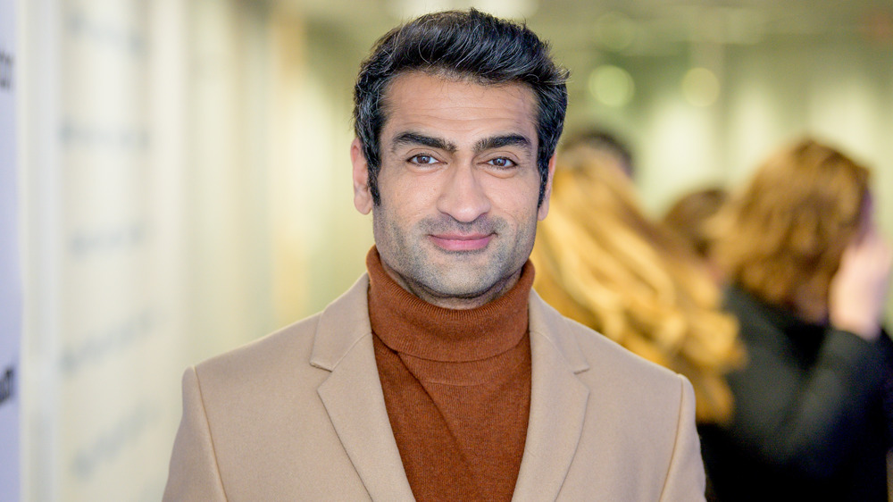 Kumail Nanjiani smiling at an event