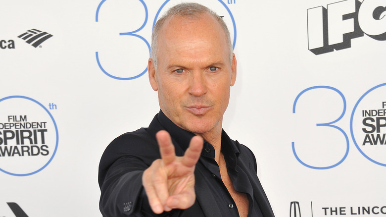 Michael Keaton giving peace sign on red carpet