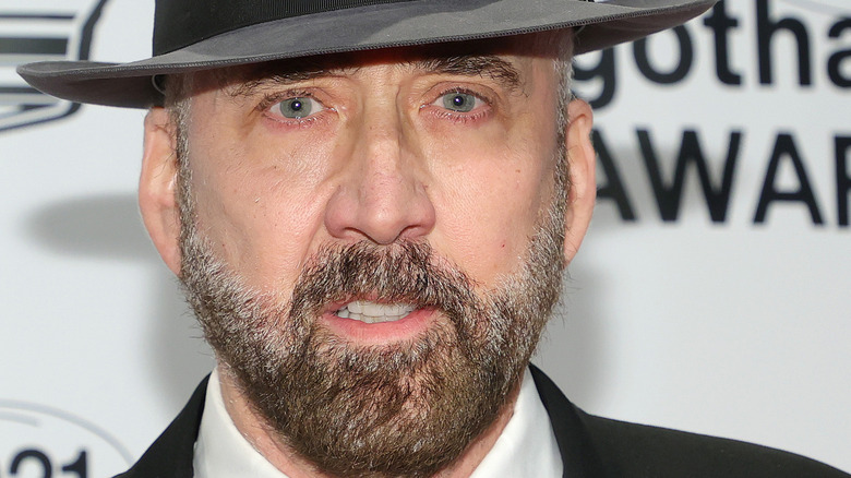 Nicolas Cage posing in a hat